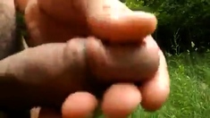 Naked cock play and cum in the sunny woods