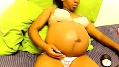 Heavily pregnant black cam chick